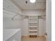 Walk-in closet with white shelving and storage at 3540 Gulf Of Mexico Dr # 303, Longboat Key, FL 34228