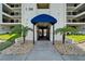 Front entryway to unit C-3540 featuring a covered walkway with palm trees at 3540 Gulf Of Mexico Dr # 303, Longboat Key, FL 34228