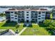 Exterior view of condos featuring well-maintained landscaping and private balconies at 3540 Gulf Of Mexico Dr # 303, Longboat Key, FL 34228