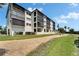 Multi-story condominium building showcasing multiple balconies and neatly landscaped grounds, perfect for outdoor enjoyment at 3540 Gulf Of Mexico Dr # 303, Longboat Key, FL 34228