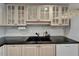 Kitchen featuring black granite counters, modern cabinetry, and stainless steel appliances at 3540 Gulf Of Mexico Dr # 303, Longboat Key, FL 34228