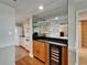 Spacious kitchen with granite countertops, a wine cooler, and wood and tile flooring at 3540 Gulf Of Mexico Dr # 303, Longboat Key, FL 34228