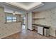 Open kitchen area with built in desk, granite countertops, tile floor, and bright natural light at 3540 Gulf Of Mexico Dr # 303, Longboat Key, FL 34228