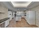 Spacious kitchen features a central island, tile floor, and bright cabinets at 3540 Gulf Of Mexico Dr # 303, Longboat Key, FL 34228