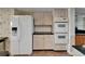 Kitchen featuring white appliances, tiled flooring, and built in ovens at 3540 Gulf Of Mexico Dr # 303, Longboat Key, FL 34228
