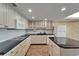 Modern kitchen with granite countertops, tile flooring, and stainless steel appliances at 3540 Gulf Of Mexico Dr # 303, Longboat Key, FL 34228