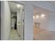 Interior shot of a laundry room and hallway featuring tile floors and neutral walls and adjacent sitting room at 3540 Gulf Of Mexico Dr # 303, Longboat Key, FL 34228