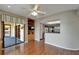 Open concept living space with balcony access, built-in shelves, and modern kitchen in the background at 3540 Gulf Of Mexico Dr # 303, Longboat Key, FL 34228