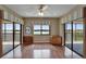 Bright open space with hardwood floors, balcony access, and serene water views from multiple windows at 3540 Gulf Of Mexico Dr # 303, Longboat Key, FL 34228