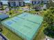 Aerial view of community pickleball and tennis courts with beautiful surrounding landscaping and trees at 3540 Gulf Of Mexico Dr # 303, Longboat Key, FL 34228
