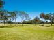 Spacious backyard featuring golf course views and mature trees at 3627 Longmeadow # 39, Sarasota, FL 34235