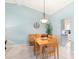 Bright dining room area with wood table and seating for six next to the kitchen at 3627 Longmeadow # 39, Sarasota, FL 34235