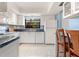 The kitchen features white cabinets, tile floors and a window over the sink providing plenty of natural light at 3627 Longmeadow # 39, Sarasota, FL 34235