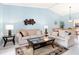 Inviting living room with tile floors, cozy furniture, and ample natural light at 3627 Longmeadow # 39, Sarasota, FL 34235
