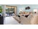 Cozy living room with tile floors, comfortable seating, and access to a screened lanai at 3627 Longmeadow # 39, Sarasota, FL 34235