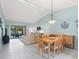 Bright and airy living room with vaulted ceilings and sliding glass doors to screened lanai at 3627 Longmeadow # 39, Sarasota, FL 34235