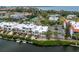 A high angle view captures these waterfront condo units, lush landscaping, and inviting, tranquil waterway at 3803 E Bay Dr # 10, Bradenton Beach, FL 34217