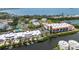 Aerial photo showcases elegant condo with serene waterfront views, landscaping, and access to community amenities at 3803 E Bay Dr # 10, Bradenton Beach, FL 34217