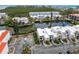 Aerial shot showcasing waterfront condo, private dock, mature landscaping and convenient parking at 3803 E Bay Dr # 10, Bradenton Beach, FL 34217