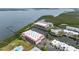 Aerial view of waterfront townhouses next to a lake and overlooking the bay at 3803 E Bay Dr # 10, Bradenton Beach, FL 34217