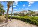 Backyard view of a charming home overlooking a serene lake and lush greenery at 3803 E Bay Dr # 10, Bradenton Beach, FL 34217
