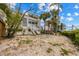 Charming home featuring backyard with stairs leading to a deck and lush palm trees at 3803 E Bay Dr # 10, Bradenton Beach, FL 34217