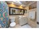 Cozy bathroom with a decorative shower curtain, framed mirror, and a bright vanity at 3803 E Bay Dr # 10, Bradenton Beach, FL 34217