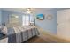 Bedroom featuring a full bed, a ceiling fan, a mounted television, and an exit door at 3803 E Bay Dr # 10, Bradenton Beach, FL 34217