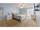 Bright bedroom featuring calming blue walls, a full bed, a dresser, and ample natural light at 3803 E Bay Dr # 10, Bradenton Beach, FL 34217