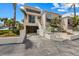 Modern condo featuring covered parking, a stairway to the front door, and lush tropical landscaping at 3803 E Bay Dr # 10, Bradenton Beach, FL 34217