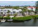 An exterior shot featuring waterfront condo with lush landscaping and convenient waterway access at 3803 E Bay Dr # 10, Bradenton Beach, FL 34217