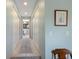 Bright hallway with neutral colors leading to a bathroom at 3803 E Bay Dr # 10, Bradenton Beach, FL 34217