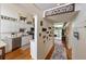 Hallway view of eat-in kitchen featuring a modern backsplash and stainless steel appliances at 3803 E Bay Dr # 10, Bradenton Beach, FL 34217