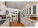 Eat-in kitchen featuring stainless appliances, quartz countertops, and hardwood flooring at 3803 E Bay Dr # 10, Bradenton Beach, FL 34217