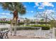 Patio overlooking the pond with mature palms and lush tropical landscaping at 3803 E Bay Dr # 10, Bradenton Beach, FL 34217