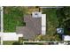 Birds-eye view of a home with a patio, fire pit and nicely manicured lawn, situated in a well-maintained neighborhood at 417 20Th W Ave, Palmetto, FL 34221