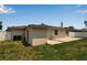 The backyard includes a lush lawn, patio area, and storage containers, offering ample outdoor space at 417 20Th W Ave, Palmetto, FL 34221