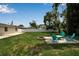 The backyard features a lawn, fire pit, and table with chairs, perfect for enjoying the outdoors at 417 20Th W Ave, Palmetto, FL 34221