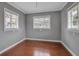 Bright bedroom with hardwood floors, three windows, and neutral gray walls create a serene atmosphere at 417 20Th W Ave, Palmetto, FL 34221