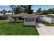 Home featuring a carport and a well-manicured lawn at 417 20Th W Ave, Palmetto, FL 34221