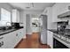 Bright kitchen featuring white cabinets, black granite countertops, stainless steel appliances, and hardwood floors at 417 20Th W Ave, Palmetto, FL 34221
