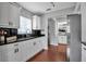 Modern kitchen featuring sleek white cabinetry, dark granite countertops, and stainless steel appliances at 417 20Th W Ave, Palmetto, FL 34221