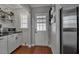 Charming kitchen with white cabinets, wood floors, and view of the back door at 417 20Th W Ave, Palmetto, FL 34221