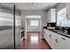 Bright kitchen featuring white cabinets, black granite countertops, stainless steel appliances, and hardwood floors at 417 20Th W Ave, Palmetto, FL 34221