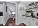 Kitchenette and hallway view with modern appliances, shelving, and decor at 417 20Th W Ave, Palmetto, FL 34221
