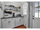 Kitchenette with white cabinets, black granite countertops, and stainless steel shelving at 417 20Th W Ave, Palmetto, FL 34221