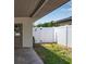 Backyard patio area featuring a secure white fence and a convenient gate at 417 20Th W Ave, Palmetto, FL 34221