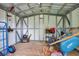 Well-lit shed interior with a metal frame for tools and outdoor equipment, adding to functionality at 417 20Th W Ave, Palmetto, FL 34221