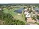 Aerial view of a lush golf course community with a lake and luxurious homes at 431 Fieldstone Dr, Venice, FL 34292