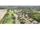 Aerial view of the neighborhood with homes situated around a golf course and ponds at 431 Fieldstone Dr, Venice, FL 34292